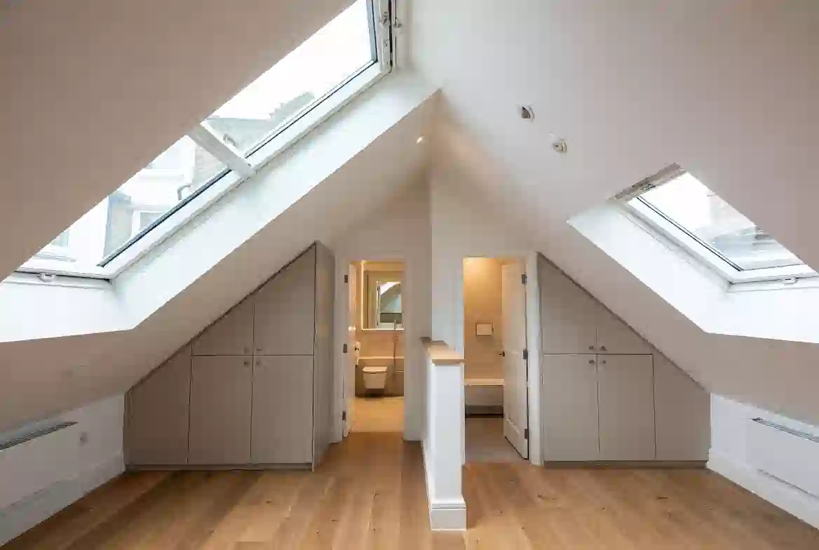 Mansard loft conversion with slate-clad cheeks on a Victorian terrace in Battersea, South London